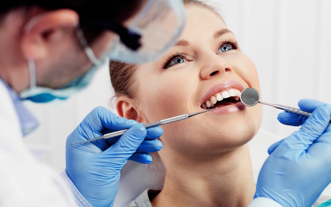 Woman Having Teeth Checked by Dentist