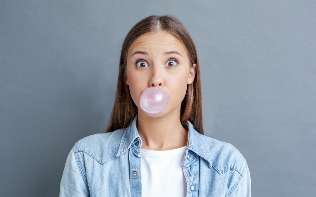 teenager blowing bubble gum