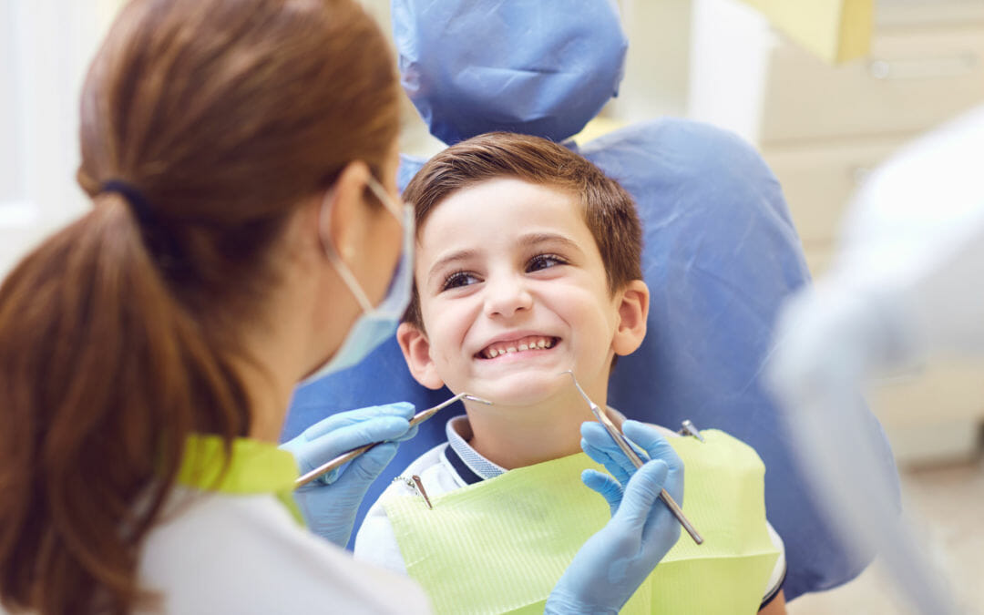 smiling kid at first dentist visit